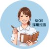 Cartoon illustration of a smiling woman in a striped shirt holding a pen and an open planner, set against a light blue circular background.